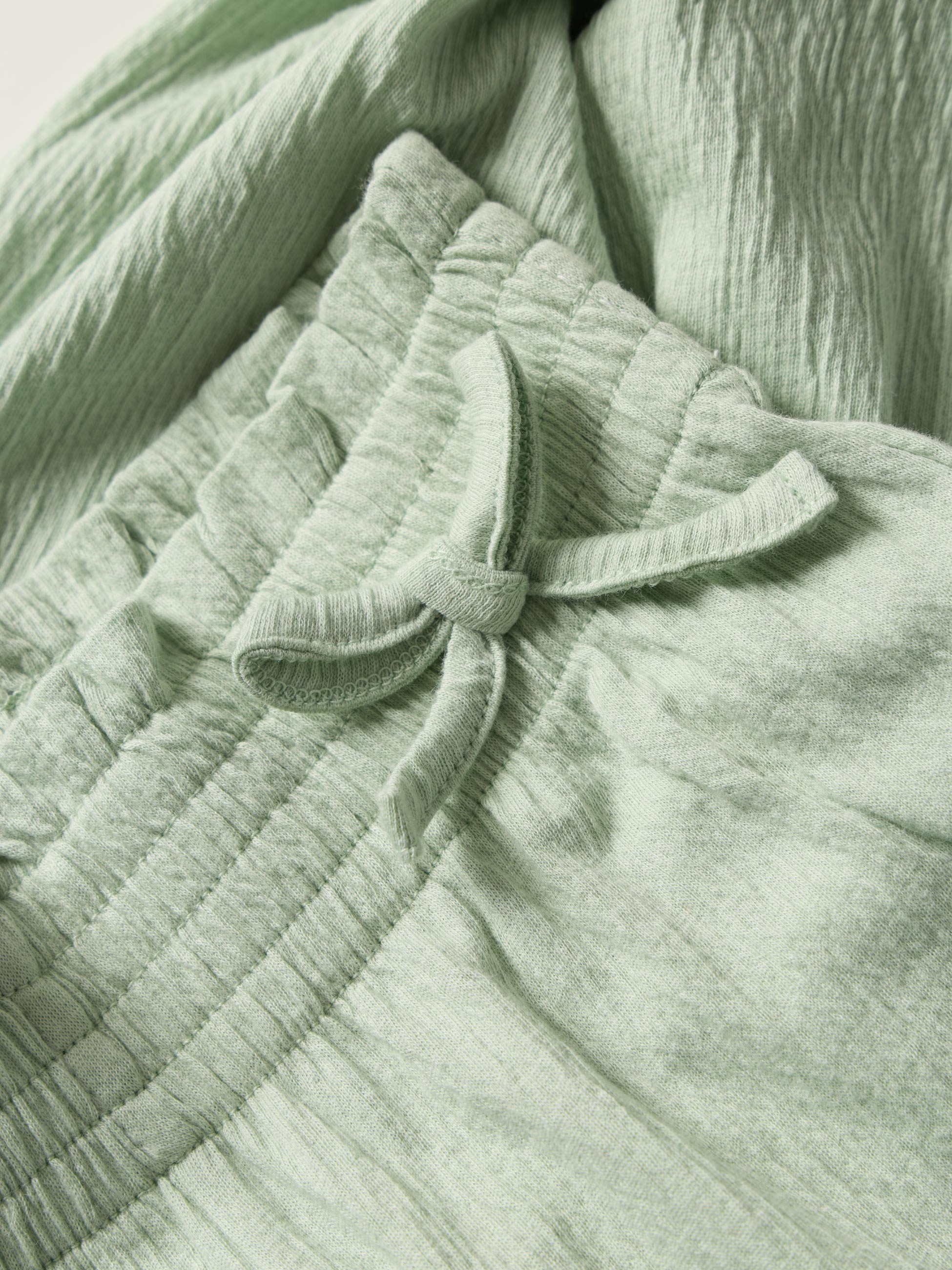 Calças fluídas com laços